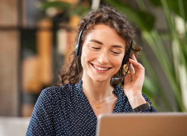 Girl with headset sitting in front of laptop