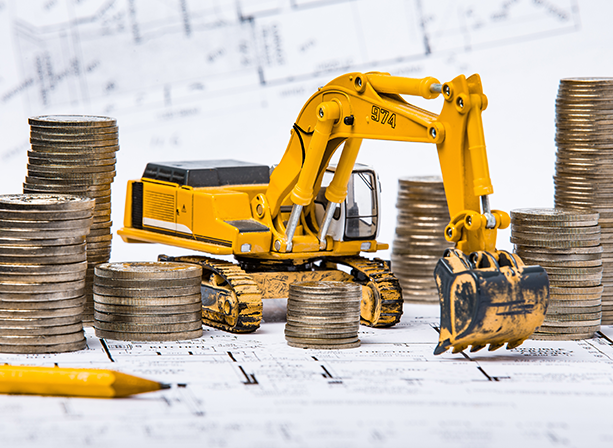 excavator surrounded by quarters and blueprints